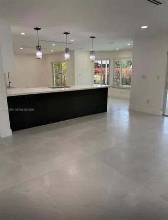 a view of a kitchen with a sink stainless steel appliances and cabinets