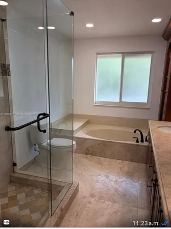 a bathroom with a tub and a shower