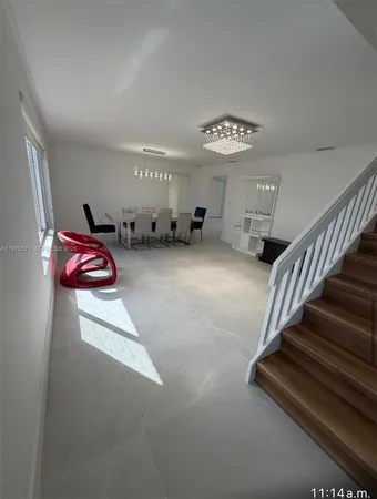 a view of a livingroom with furniture and stairs