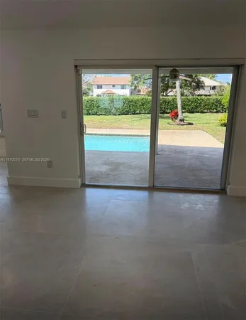 a view of empty room with floor to ceiling window