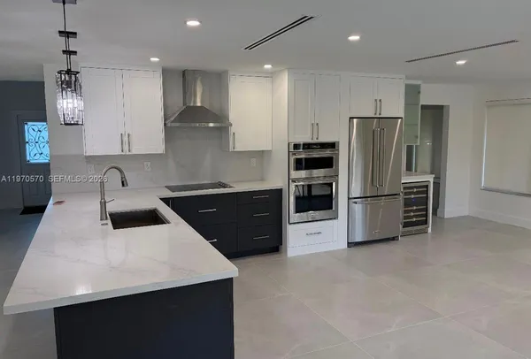 a kitchen with stainless steel appliances a refrigerator and a sink