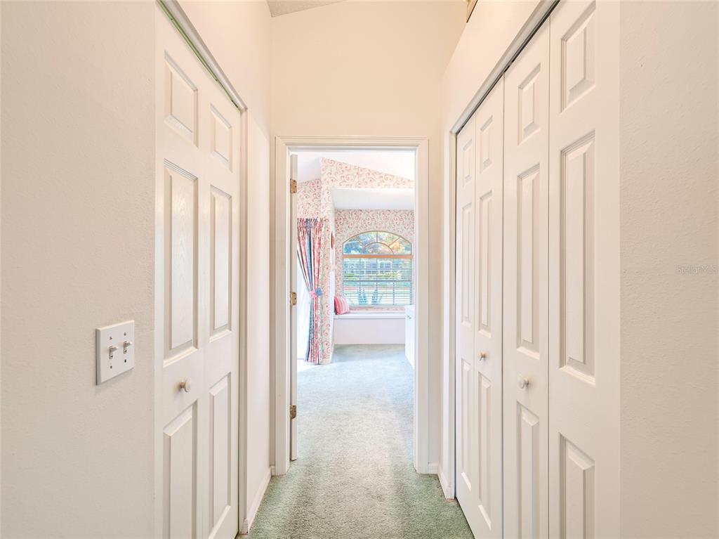 11228 Windrush Circle Hudson, FL 34667 - Photo 31 of 67 a view of a hallway with wooden floor and windows