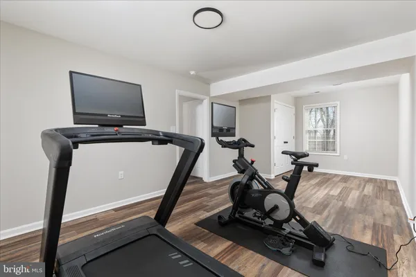 a room with gym equipment and a flat screen tv