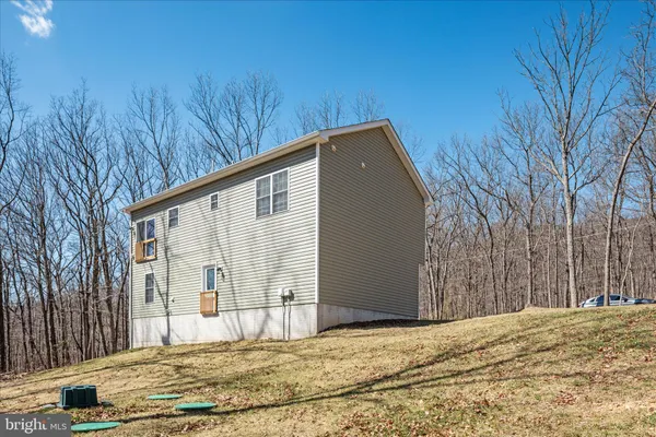a view of house with backyard and trees