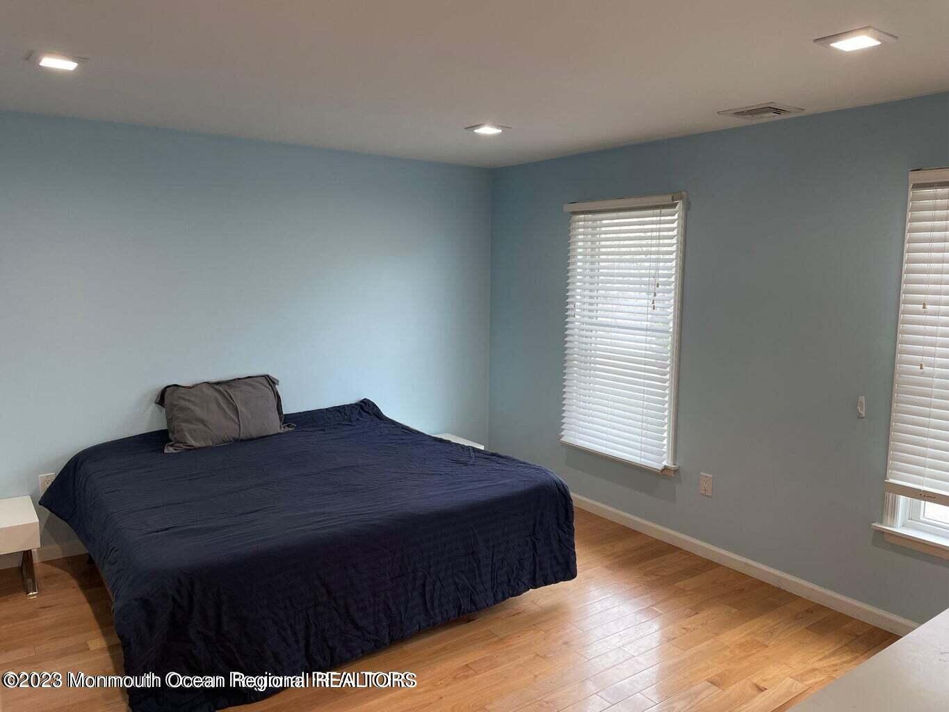 108 Poplar Avenue Deal, NJ 07723 - Photo 12 of 17 a large bed sitting in a bedroom next to a window