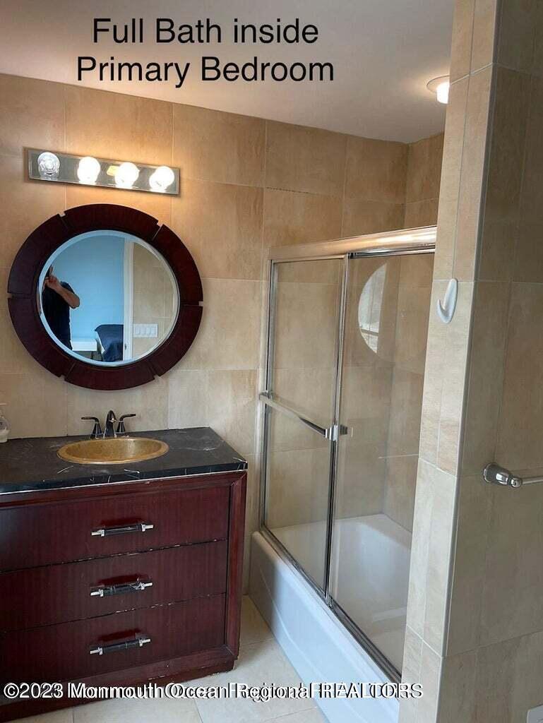 108 Poplar Avenue Deal, NJ 07723 - Photo 14 of 17 a bathroom with a sink and a mirror
