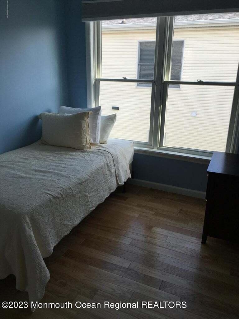 108 Poplar Avenue Deal, NJ 07723 - Photo 7 of 17 a bed sitting in a bedroom next to a window