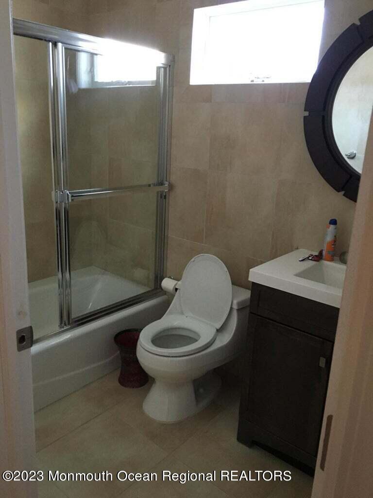 108 Poplar Avenue Deal, NJ 07723 - Photo 8 of 17 a bathroom with a toilet a sink and shower