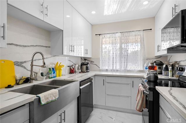 a kitchen with a sink cabinets and window