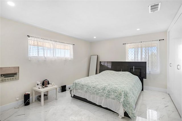 a bedroom with a bed and chair