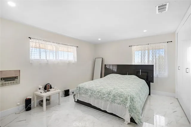 a bedroom with a bed and chair