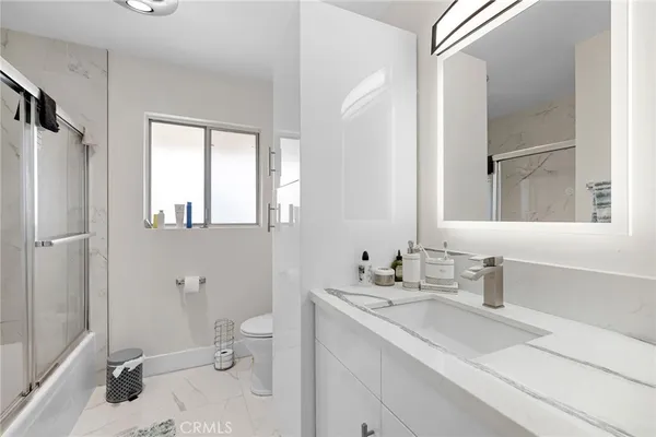 a bathroom with a sink toilet tub and shower