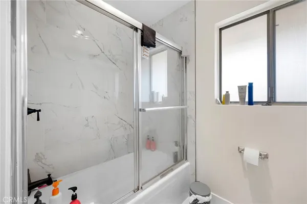 a bathroom with a bathtub and a shower