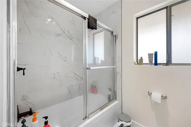 a bathroom with a bathtub and a shower