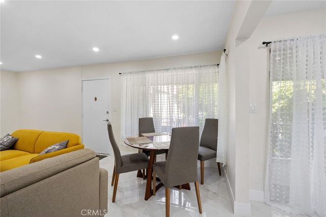 a view of a dining room with furniture and a window