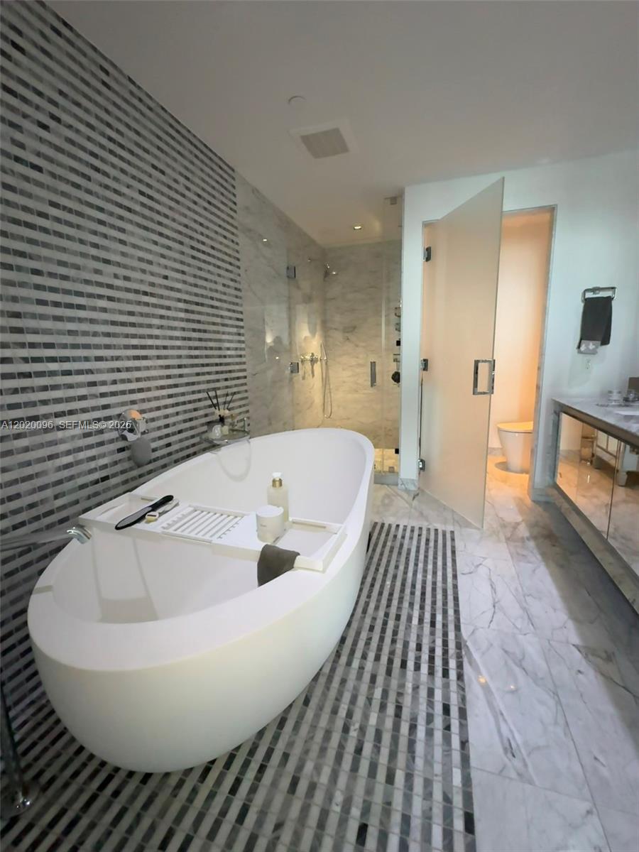 788 Northeast 23rd Street, Unit 1202 Miami, FL 33137 - Photo 21 of 64 a spacious bathroom with a bathtub and a sink