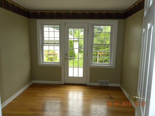 248 Iroquois Road Hillside, IL 60162 - Photo 6 of 8 a view of an empty room with wooden floor and a window