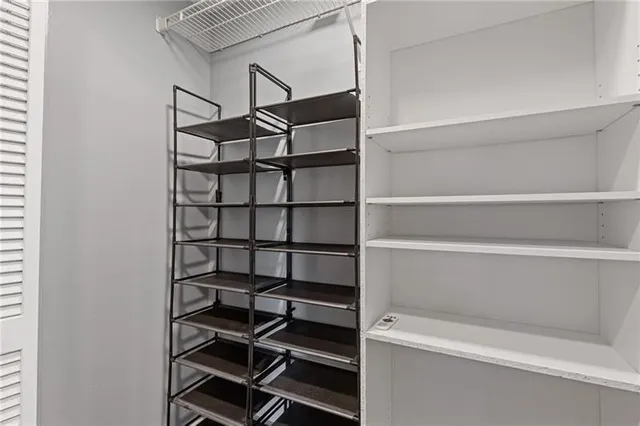 a view of walk in closet with empty racks