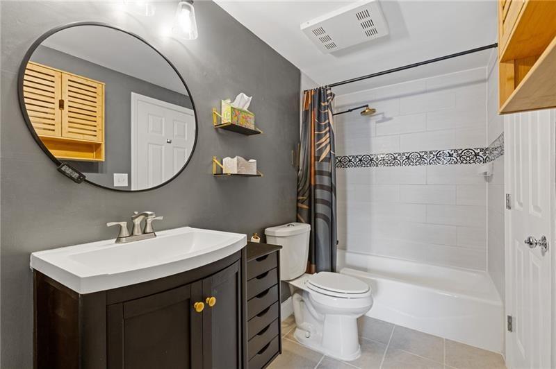 3481 Lakeside Drive Northeast, Unit 901 Atlanta, GA 30326 - Photo 16 of 38 a bathroom with a sink a toilet and a mirror