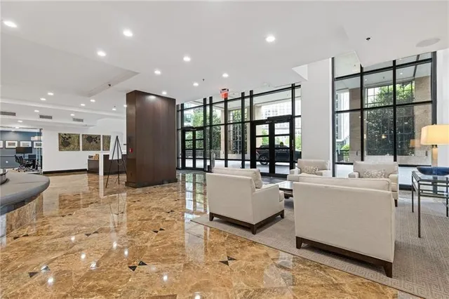 a living room with furniture a large window and flat screen tv