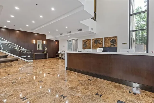a living room with furniture a rug and a large window
