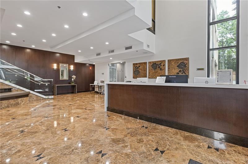 3481 Lakeside Drive Northeast, Unit 901 Atlanta, GA 30326 - Photo 20 of 38 a large room with a large window and wooden floor