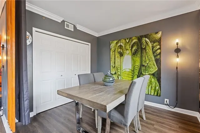 a view of a dining table in a hall with wooden floor