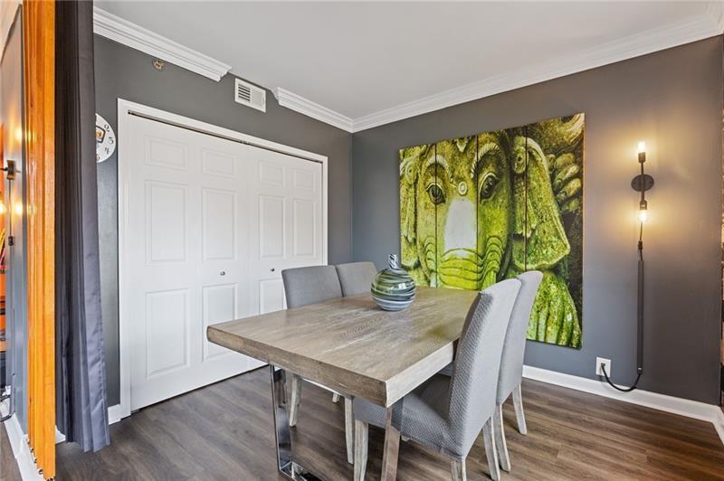 3481 Lakeside Drive Northeast, Unit 901 Atlanta, GA 30326 - Photo 2 of 38 a view of a dining table in a hall with wooden floor