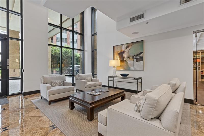 3481 Lakeside Drive Northeast, Unit 901 Atlanta, GA 30326 - Photo 21 of 38 a living room with furniture a rug and a large window