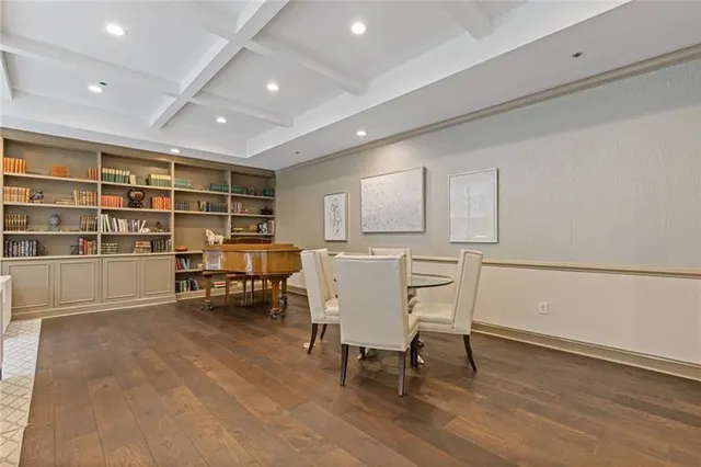 a view of a a dining room with furniture window and wooden floor