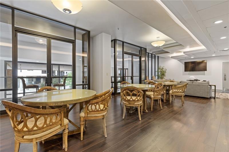 3481 Lakeside Drive Northeast, Unit 901 Atlanta, GA 30326 - Photo 26 of 38 a view of a dining room with furniture window and wooden floor