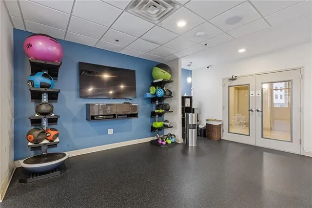 a view of a large building with a swimming pool and outdoor seating