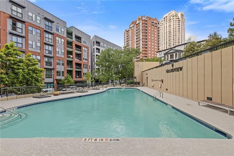 3481 Lakeside Drive Northeast, Unit 901 Atlanta, GA 30326 - Photo 33 of 38 a view of a large building with a swimming pool and outdoor seating