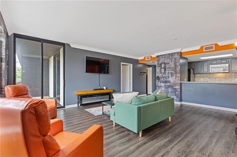 3481 Lakeside Drive Northeast, Unit 901 Atlanta, GA 30326 - Photo 5 of 38 a living room with furniture and a flat screen tv