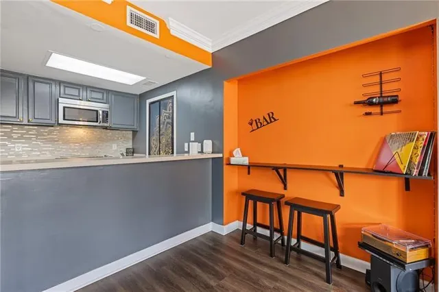 a kitchen with stainless steel appliances granite countertop a refrigerator and stove