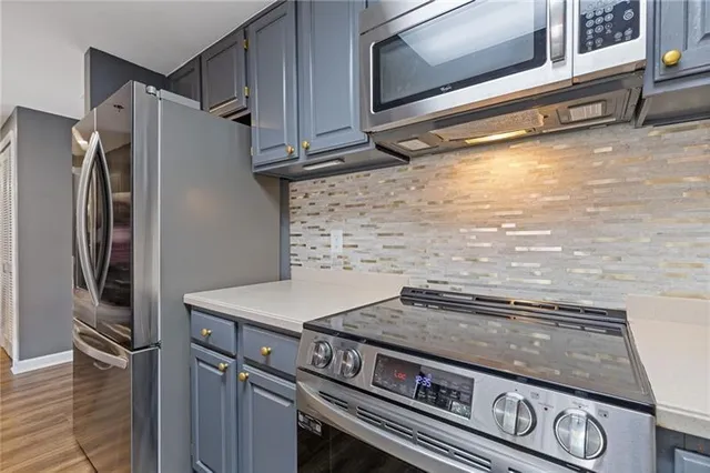 a kitchen with granite countertop a stove and a microwave