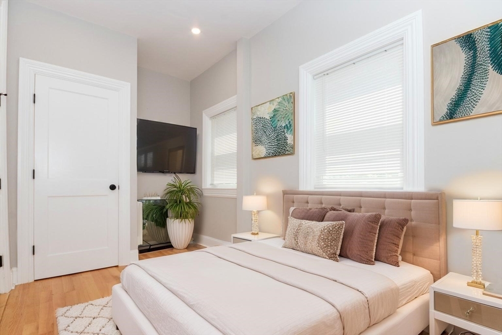 14 Grant Street Boston, MA 02125 - Photo 11 of 17 a bedroom with a bed and a large window