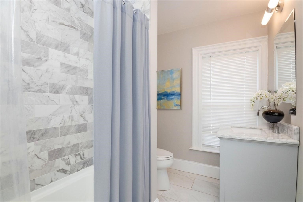 14 Grant Street Boston, MA 02125 - Photo 12 of 17 a bathroom with a granite countertop sink a toilet and shower