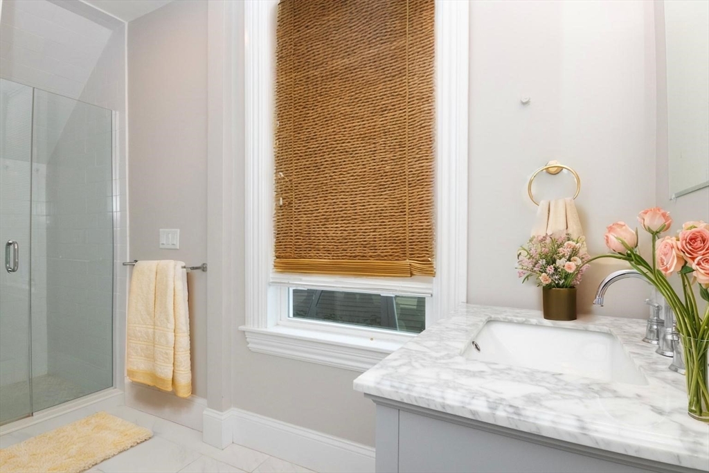 14 Grant Street Boston, MA 02125 - Photo 13 of 17 a bathroom with a granite countertop sink and a bathtub