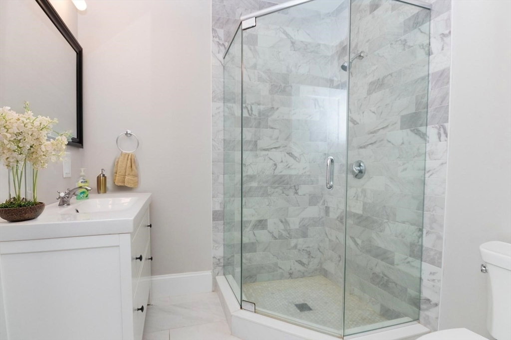 14 Grant Street Boston, MA 02125 - Photo 14 of 17 a bathroom with a shower a sink and mirror