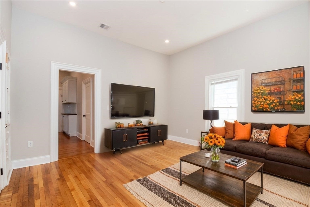 14 Grant Street Boston, MA 02125 - Photo 3 of 17 a living room with furniture and a flat screen tv
