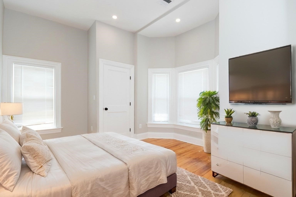 14 Grant Street Boston, MA 02125 - Photo 5 of 17 a bedroom with a bed and a flat screen tv