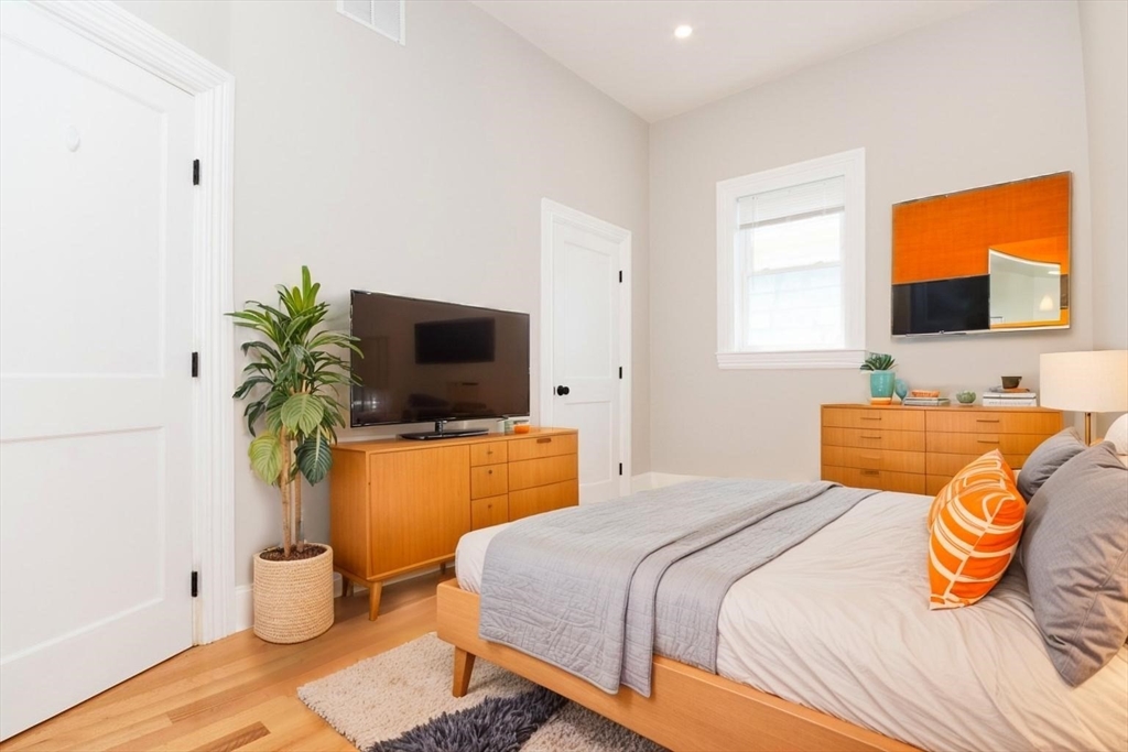 14 Grant Street Boston, MA 02125 - Photo 6 of 17 a bedroom with a bed and flat screen tv