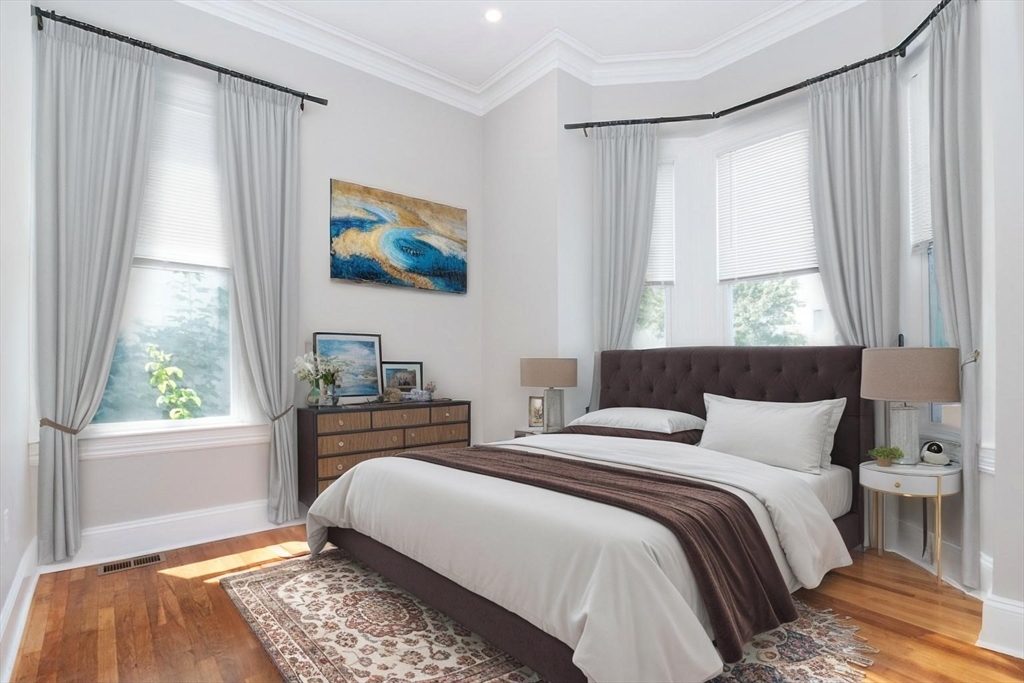 14 Grant Street Boston, MA 02125 - Photo 9 of 17 a bedroom with a bed and a window