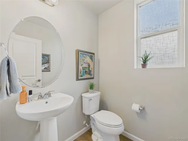 a bathroom with a sink a mirror and a toilet