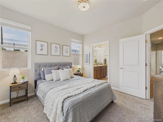 a bedroom with a bed and a view of kitchen