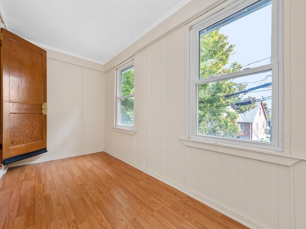 194 School Street, Unit 194 Watertown, MA 02472 - Photo 11 of 24 an empty room with wooden floor and windows