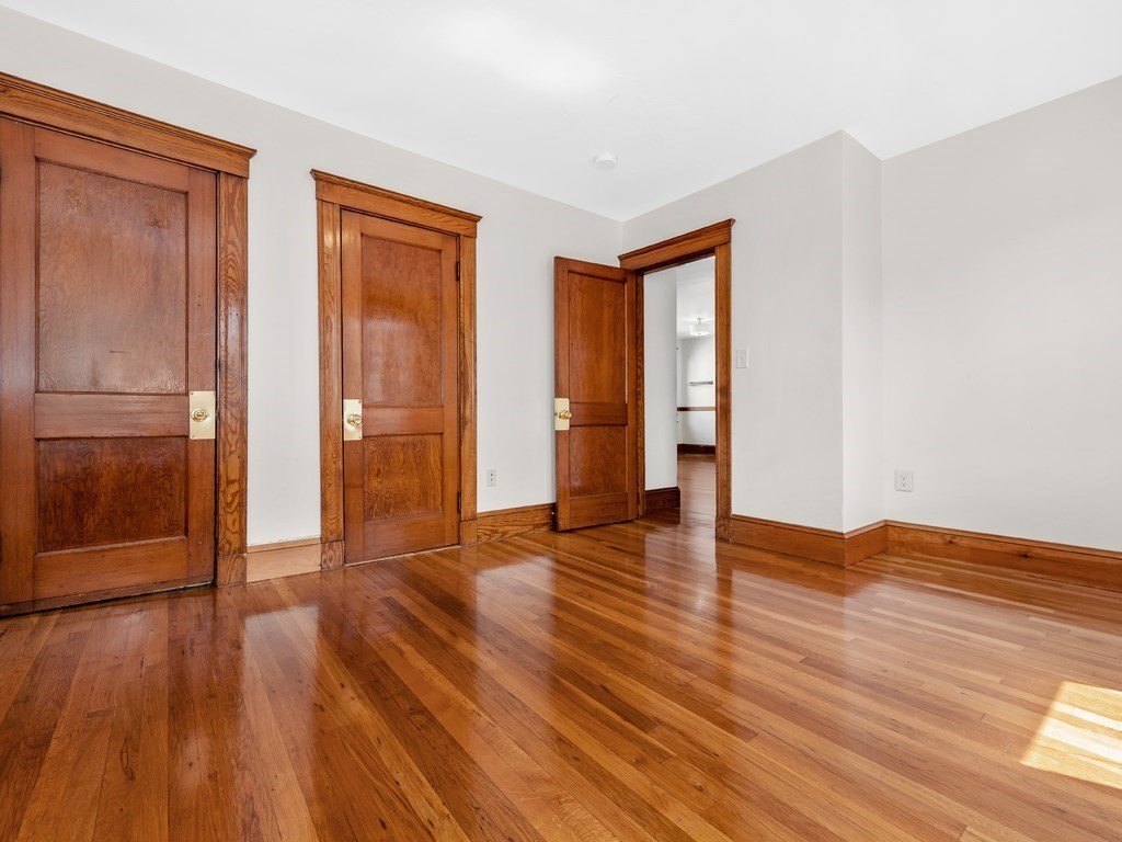 194 School Street, Unit 194 Watertown, MA 02472 - Photo 12 of 24 a view of an empty room with wooden floor and a window