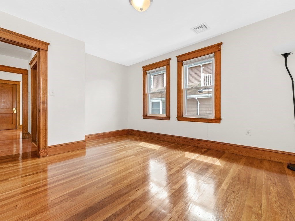 194 School Street, Unit 194 Watertown, MA 02472 - Photo 13 of 24 a view of empty room with wooden floor and fan