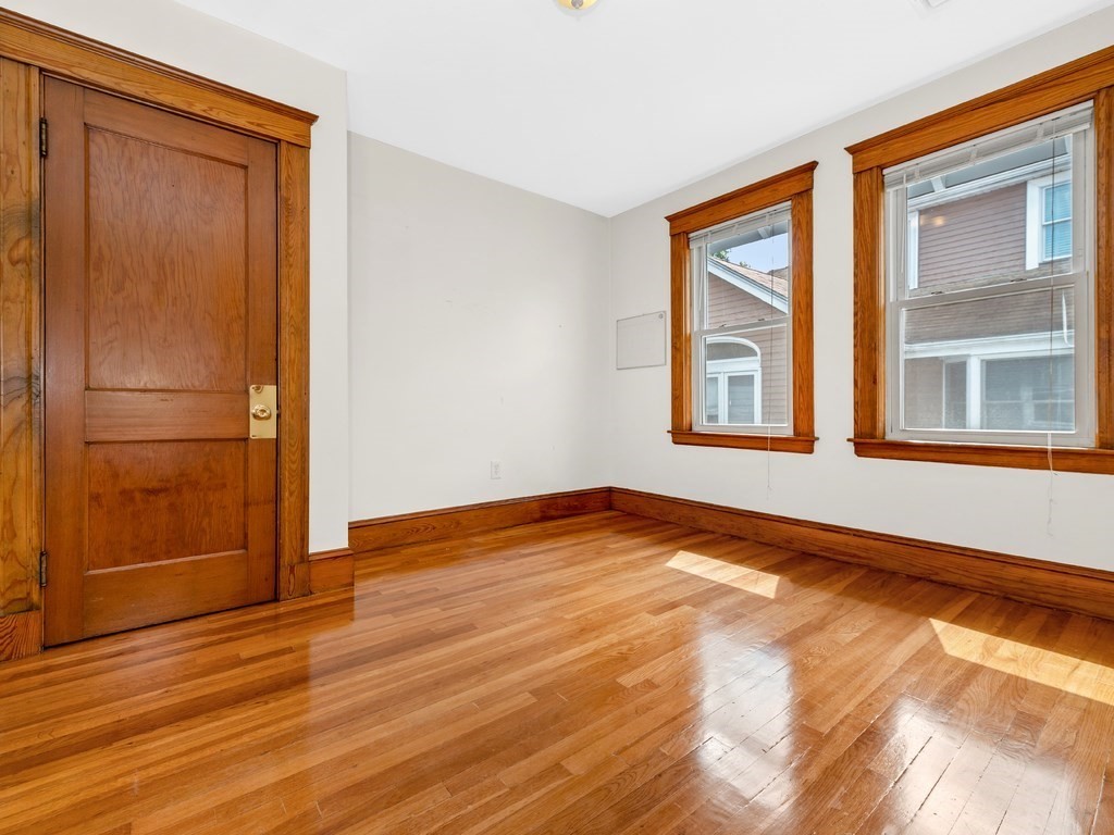 194 School Street, Unit 194 Watertown, MA 02472 - Photo 15 of 24 a view of an empty room with wooden floor and a window